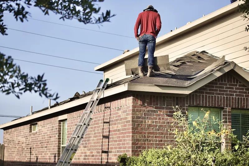Professional roofer working on a residential roof in Sioux Center